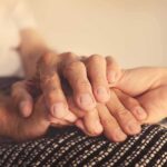 hand holding an elderly person's hands