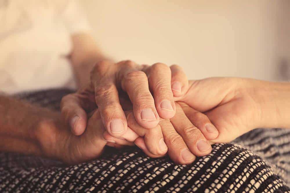 hand holding an elderly person's hands