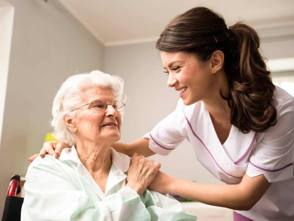 a caregiver comforting an elderly woman