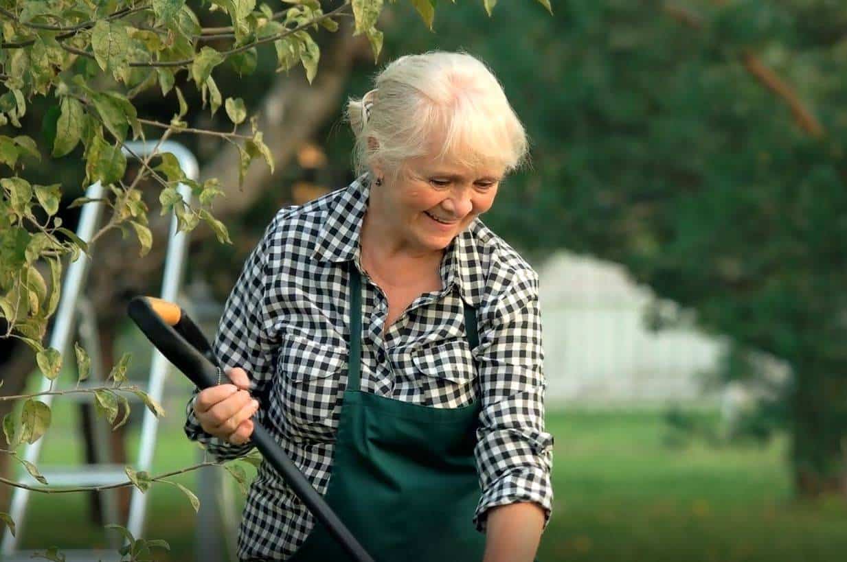 a senior woman working in her garden