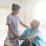 a caregiver shaking hands with a senior woman