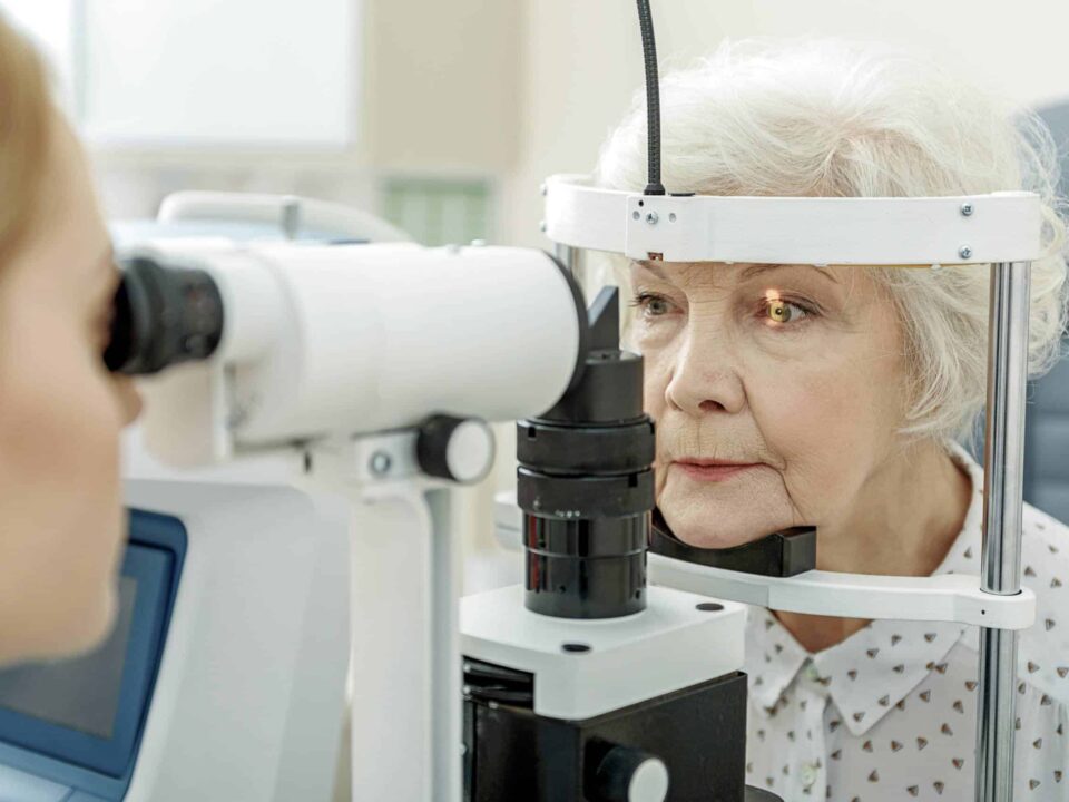an elderly woman getting her eyes tested